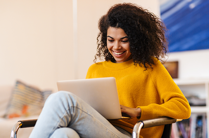Woman with an smile checking her laptop